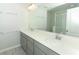 Bright bathroom with a double vanity, light grey cabinets, and a large mirror at 3031 Pilot House Pl, Oviedo, FL 32765