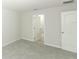 Bright and airy bedroom featuring soft gray carpet, a window, and direct access to an ensuite bathroom at 3031 Pilot House Pl, Oviedo, FL 32765