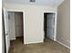 Bedroom features a beige carpet, electrical outlets, and two closets at 3307 Greenwich Village Blvd # 205, Orlando, FL 32835