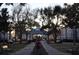 Welcoming community entrance features manicured landscaping and a charming clock tower building at 3307 Greenwich Village Blvd # 205, Orlando, FL 32835