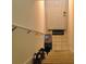 A staircase leads to the front door with a 'welcome' mat at 3307 Greenwich Village Blvd # 205, Orlando, FL 32835