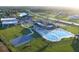 Aerial view of community amenities with swimming pools, a basketball court, and green spaces at 400 Miami Way, Poinciana, FL 34759