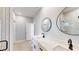 Bathroom featuring double sinks, quartz countertop, black hardware, and a modern walk-in shower at 400 Miami Way, Poinciana, FL 34759