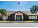 Association of Poinciana Villages building featuring a well-maintained facade and palm trees at 400 Miami Way, Poinciana, FL 34759