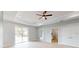 Bright living room with stylish ceiling detail, fan, and sliding glass doors at 400 Miami Way, Poinciana, FL 34759