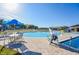 Community pool featuring seating, umbrellas, and a splash area under clear skies at 400 Miami Way, Poinciana, FL 34759