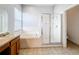 Bright bathroom featuring a separate glass shower and a soaking tub near a large vanity with sink at 4012 Longworth Loop, Kissimmee, FL 34744