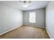 Simple bedroom with neutral walls, plush carpet, a window, and a ceiling fan with light at 4012 Longworth Loop, Kissimmee, FL 34744