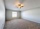 Bright bedroom with carpet, a ceiling fan, and a large window providing natural light at 4012 Longworth Loop, Kissimmee, FL 34744