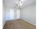 Cozy bedroom featuring neutral walls, plush carpet, two doors and a ceiling fan with light at 4012 Longworth Loop, Kissimmee, FL 34744