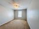 Bedroom with neutral walls, plush carpet, a window, and a ceiling fan with light at 4012 Longworth Loop, Kissimmee, FL 34744