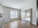 Bright dining area with wood-look tile floors, sliding glass doors, and a large window offering plenty of natural light at 4012 Longworth Loop, Kissimmee, FL 34744