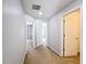 Hallway with neutral paint and carpet, leading to several rooms in the home at 4012 Longworth Loop, Kissimmee, FL 34744