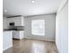 Bright kitchen with stainless steel appliances, white cabinets, granite countertops, and wood-look tile flooring at 4012 Longworth Loop, Kissimmee, FL 34744