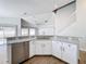 Modern kitchen featuring stainless steel appliances, granite countertops, white cabinetry, and an island with sink at 4012 Longworth Loop, Kissimmee, FL 34744