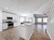 Modern kitchen featuring white cabinets, granite countertops, stainless steel appliances, and an island with sink at 4012 Longworth Loop, Kissimmee, FL 34744