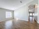 Bright, open living room with wood-look flooring and a view of the entry foyer at 4012 Longworth Loop, Kissimmee, FL 34744