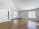 Bright living room with wood-look tile flooring, vaulted ceiling, and a front door with decorative glass at 4012 Longworth Loop, Kissimmee, FL 34744