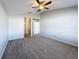 Large main bedroom with vaulted ceilings, carpet flooring, a ceiling fan, and en-suite bathroom access at 4012 Longworth Loop, Kissimmee, FL 34744