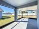 Enclosed screened porch offering a view of the backyard and blue sky at 4012 Longworth Loop, Kissimmee, FL 34744