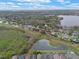 Sprawling aerial shot showcasing a residential area adjacent to a serene lake and green spaces at 4200 Bear Gully Rd, Winter Park, FL 32792