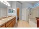 Bright bathroom boasts double sinks, a large mirror, and a glass-enclosed shower with a separate soaking tub at 4200 Bear Gully Rd, Winter Park, FL 32792