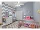 Stylish bedroom with chevron accent wall, plush carpet, and white furniture, creating a cozy space at 4200 Bear Gully Rd, Winter Park, FL 32792