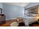 Cozy bedroom featuring wood flooring, a panel accent wall, and neutral color scheme at 4200 Bear Gully Rd, Winter Park, FL 32792