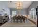 Open dining area with modern lighting, a large table, and stylish decor, perfect for entertaining guests at 4200 Bear Gully Rd, Winter Park, FL 32792