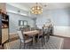 Bright dining room featuring a large wooden table, gray upholstered chairs, and elegant decorative touches at 4200 Bear Gully Rd, Winter Park, FL 32792