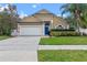 Beautiful single-story home with well-kept landscaping, a two car garage, and a bright blue front door at 4200 Bear Gully Rd, Winter Park, FL 32792