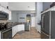 Bright kitchen featuring granite countertops, stainless steel appliances, a pantry, and wood-look floors at 4200 Bear Gully Rd, Winter Park, FL 32792