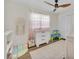 Neutral bedroom with a ceiling fan, area rug, and natural light at 4520 Lake Gem Cir, Orlando, FL 32806