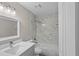 Modern bathroom with vanity, toilet, and tiled shower and tub at 4870 Oriole Dr, St Cloud, FL 34772