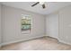 Bedroom featuring a window and a closet with paneled doors and wood-look flooring at 4870 Oriole Dr, St Cloud, FL 34772