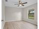 Bright bedroom with a ceiling fan, light-colored walls, and light wood-look flooring at 4870 Oriole Dr, St Cloud, FL 34772