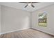 Bright bedroom with a ceiling fan, light-colored walls, and light wood-look flooring at 4870 Oriole Dr, St Cloud, FL 34772