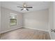 Bright bedroom with a ceiling fan, light-colored walls, and light wood-look flooring at 4870 Oriole Dr, St Cloud, FL 34772