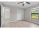 Bedroom featuring a window and a closet with paneled doors and wood-look flooring at 4870 Oriole Dr, St Cloud, FL 34772