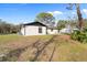 View of the back of the house showing a well maintained lawn and fresh paint at 4870 Oriole Dr, St Cloud, FL 34772