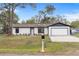 Charming single-story home featuring a freshly painted exterior, new landscaping and attached two-car garage at 4870 Oriole Dr, St Cloud, FL 34772