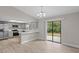 Living and dining area with modern wood-look floors, a ceiling fan, and sliding glass doors to the backyard at 4870 Oriole Dr, St Cloud, FL 34772