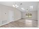 Open living room with wood-look floors, skylights, and a chandelier, creating a bright and airy atmosphere at 4870 Oriole Dr, St Cloud, FL 34772