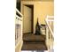 Carpeted staircase with white railing leading to a landing with a door at 4944 Sanoma Vlg # D, Orlando, FL 32808