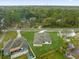 Aerial view of a home in a lush, green neighborhood with mature trees and landscaping at 501 Dean Creek Ln, Orlando, FL 32825