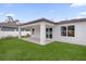 A covered patio in the fenced backyard offers a space for relaxing or entertaining at 501 Dean Creek Ln, Orlando, FL 32825