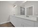 Bathroom with white vanity, dual sinks, and marble walk-in shower at 501 Dean Creek Ln, Orlando, FL 32825