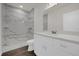 Well-lit bathroom with white vanity, marble accent wall, and walk-in shower at 501 Dean Creek Ln, Orlando, FL 32825