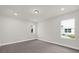 A serene bedroom boasts neutral carpet, natural light and a minimalist aesthetic at 501 Dean Creek Ln, Orlando, FL 32825