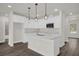 Bright kitchen featuring an island with quartz countertop, stainless steel appliances, and pendant lighting at 501 Dean Creek Ln, Orlando, FL 32825